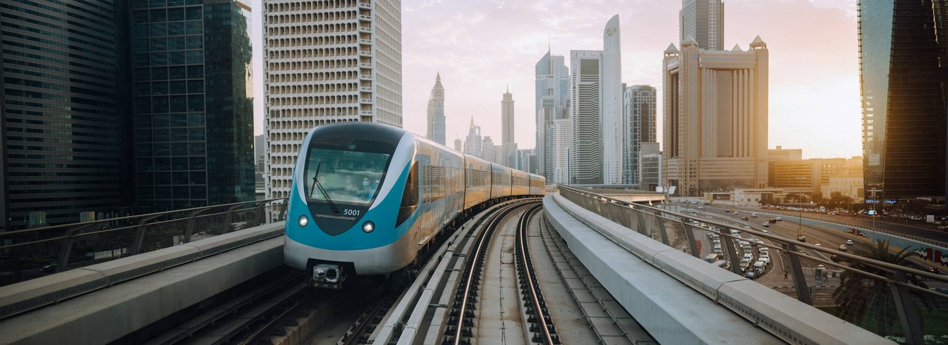 The Dubai Metro line running between towers at first light